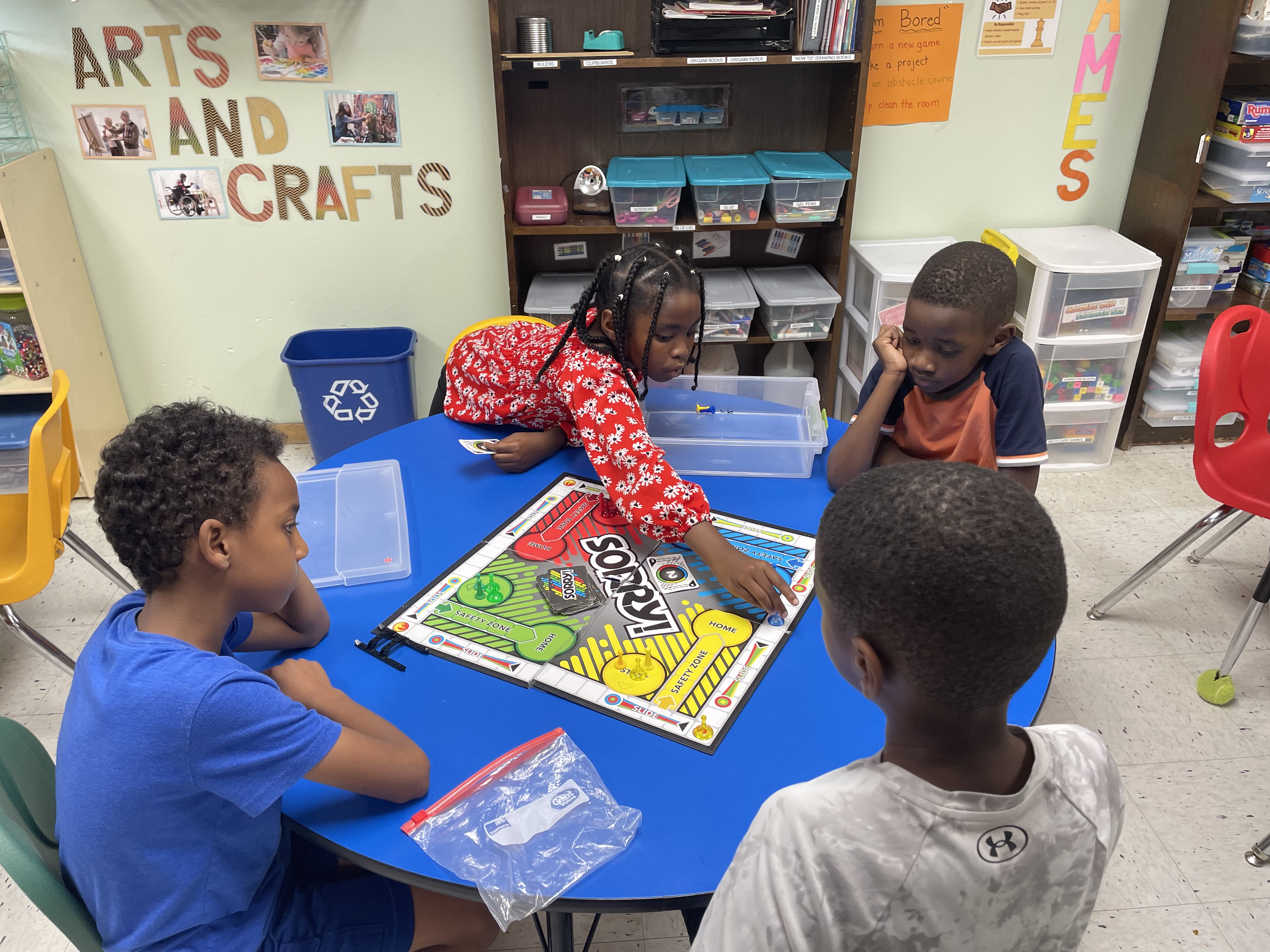 Children playing a board game together in the Pheasant Ridge Afterschool program